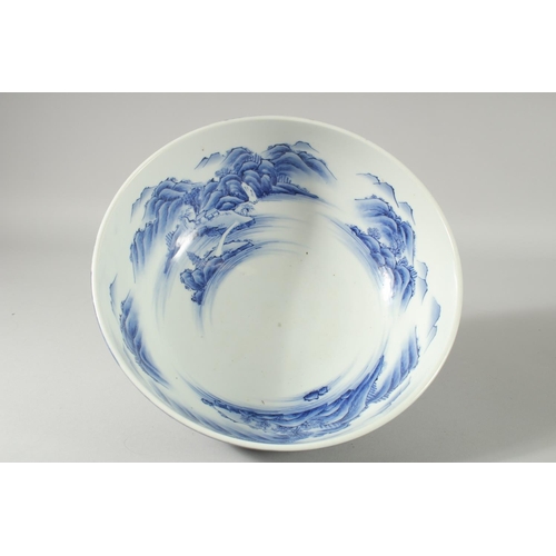 155 - A LARGE CHINESE BLUE AND WHITE PORCELAIN BOWL, the interior painted with a continuous mountainous la... 