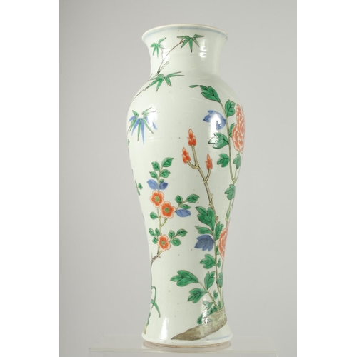 160 - A CHINESE WUCAI PORCELAIN BALUSTER VASE, painted with an exotic bird on a rocky mound and native flo... 