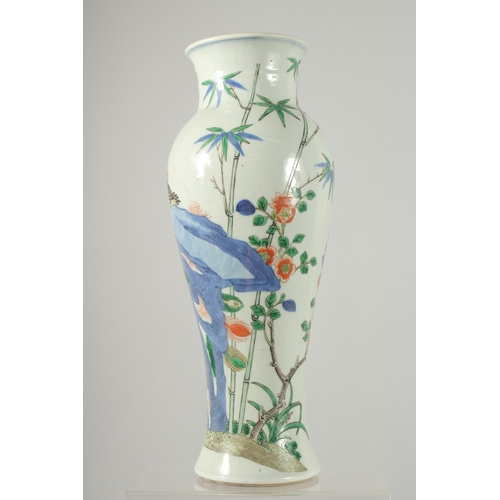 160 - A CHINESE WUCAI PORCELAIN BALUSTER VASE, painted with an exotic bird on a rocky mound and native flo... 