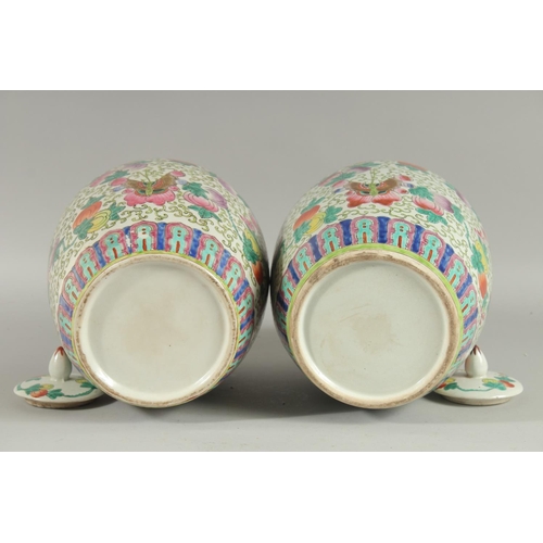 163 - A PAIR OF CHINESE FAMILLE ROSE PORCELAIN JARS AND COVERS, painted with peaches and butterflies, 31cm... 