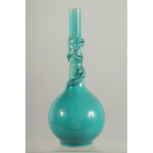 165 - A CHINESE TURQUOISE GLAZE BOTTLE VASE, with carved relief dragon coiled around the neck, 28cm high.