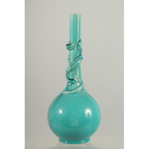 165 - A CHINESE TURQUOISE GLAZE BOTTLE VASE, with carved relief dragon coiled around the neck, 28cm high.