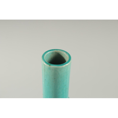 165 - A CHINESE TURQUOISE GLAZE BOTTLE VASE, with carved relief dragon coiled around the neck, 28cm high.