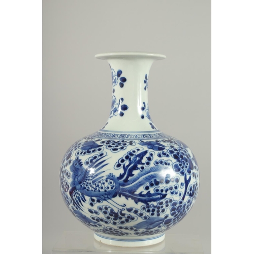 166 - A FINE CHINESE BLUE AND WHITE PORCELAIN KENDI, painted with exotic birds and flora, 26cm high.