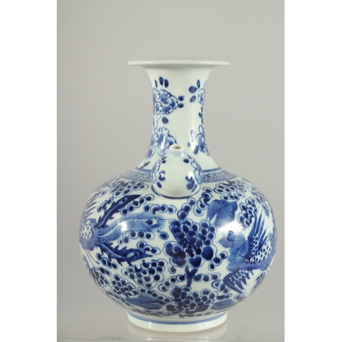 166 - A FINE CHINESE BLUE AND WHITE PORCELAIN KENDI, painted with exotic birds and flora, 26cm high.