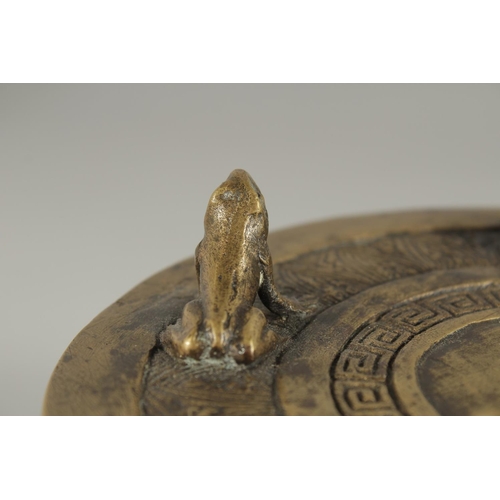 173 - AN ANNAMESE BRONZE RAIN DRUM WITH RELIEF CAST FROGS, 16cm diameter.