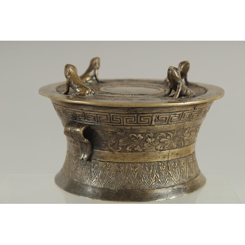 173 - AN ANNAMESE BRONZE RAIN DRUM WITH RELIEF CAST FROGS, 16cm diameter.