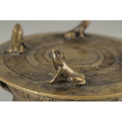 173 - AN ANNAMESE BRONZE RAIN DRUM WITH RELIEF CAST FROGS, 16cm diameter.