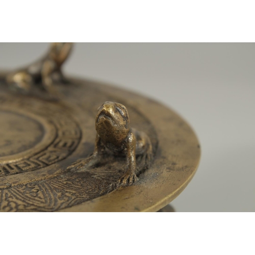 173 - AN ANNAMESE BRONZE RAIN DRUM WITH RELIEF CAST FROGS, 16cm diameter.