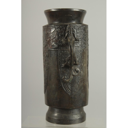 174 - A CHINESE BRONZE VASE WITH TWIN CHILONG HANDLES, with archaic style mask decoration, 28cm high.