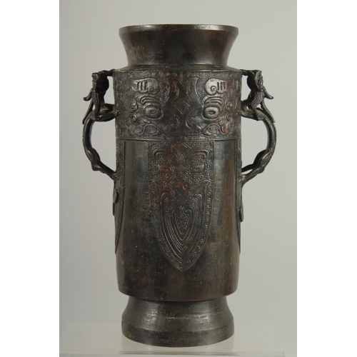 174 - A CHINESE BRONZE VASE WITH TWIN CHILONG HANDLES, with archaic style mask decoration, 28cm high.