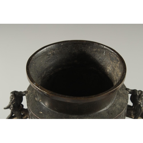 174 - A CHINESE BRONZE VASE WITH TWIN CHILONG HANDLES, with archaic style mask decoration, 28cm high.