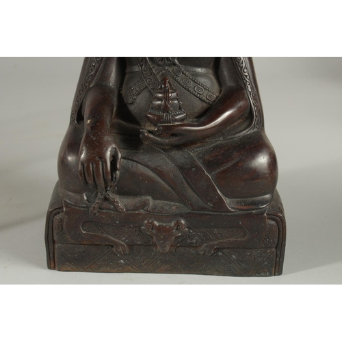 175 - A FINE TIBETAN BRONZE FIGURE OF LAMA TROPTE TUNGDEN DJABO, with long beard and hair gathered in a bu... 