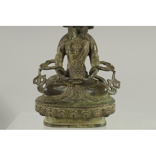 179 - A FIGURE OF A SEATED MULTI-HEADED DEITY, 22cm high.