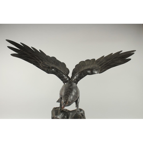 188 - AN IMPRESSIVE JAPANESE SECTIONAL BRONZE STATUE OF AN EAGLE, with wings outstretched, stood upon a ro... 