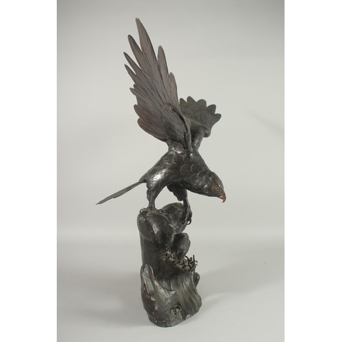 188 - AN IMPRESSIVE JAPANESE SECTIONAL BRONZE STATUE OF AN EAGLE, with wings outstretched, stood upon a ro... 