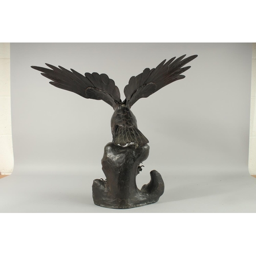 188 - AN IMPRESSIVE JAPANESE SECTIONAL BRONZE STATUE OF AN EAGLE, with wings outstretched, stood upon a ro... 