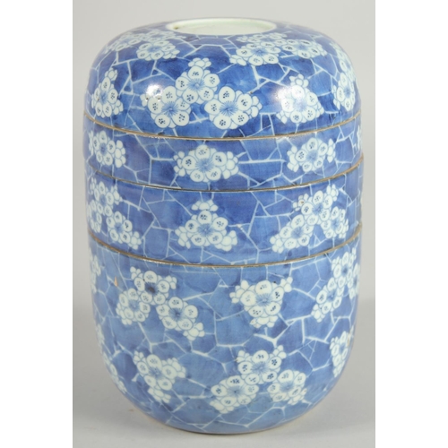 19 - A CHINESE BLUE AND WHITE PORCELAIN STACKING FOOD CONTAINER, comprising four sections, painted with f... 