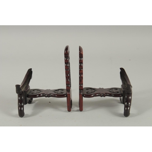 190 - A PAIR OF CHINESE CARVED AND PIERCED WOODEN STANDS.