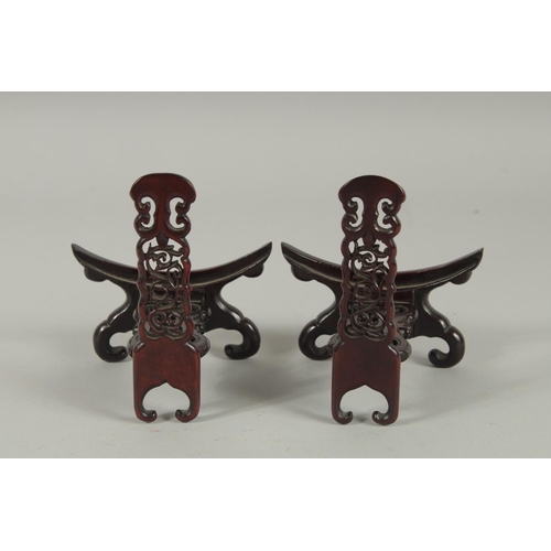 190 - A PAIR OF CHINESE CARVED AND PIERCED WOODEN STANDS.