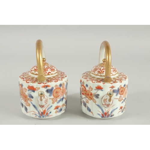 197 - A FINE PAIR OF IMARI PORCELAIN TEAPOTS, painted in the typical Imari palette with blue, red and gilt... 