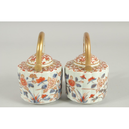 197 - A FINE PAIR OF IMARI PORCELAIN TEAPOTS, painted in the typical Imari palette with blue, red and gilt... 