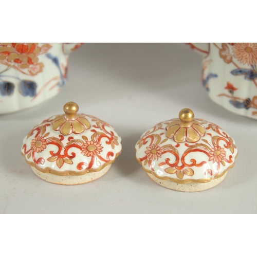 197 - A FINE PAIR OF IMARI PORCELAIN TEAPOTS, painted in the typical Imari palette with blue, red and gilt... 