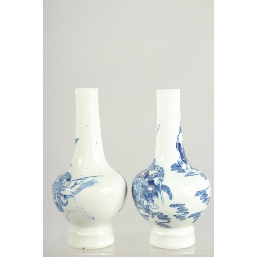 200 - A FINE PAIR OF CHINESE BLUE AND WHITE PORCELAIN BOTTLE VASES, one painted with a warrior riding a be... 