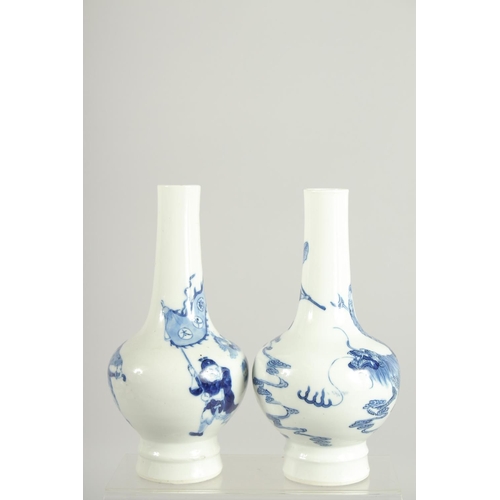 200 - A FINE PAIR OF CHINESE BLUE AND WHITE PORCELAIN BOTTLE VASES, one painted with a warrior riding a be... 