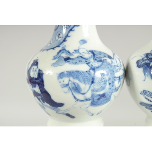 200 - A FINE PAIR OF CHINESE BLUE AND WHITE PORCELAIN BOTTLE VASES, one painted with a warrior riding a be... 