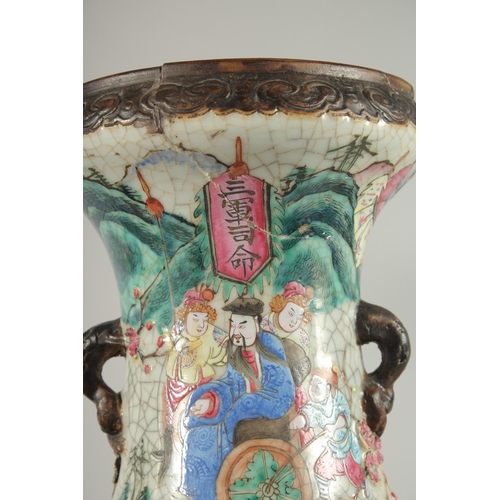 201 - A LARGE PAIR OF CHINESE FAMILLE ROSE PORCELAIN VASES, with moulded twin handles, each painted with a... 