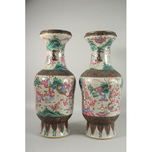 201 - A LARGE PAIR OF CHINESE FAMILLE ROSE PORCELAIN VASES, with moulded twin handles, each painted with a... 