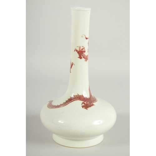 202 - A CHINESE COPPER RED AND WHITE PORCELAIN BOTTLE VASE, the neck with coiled dragon, six-character mar... 