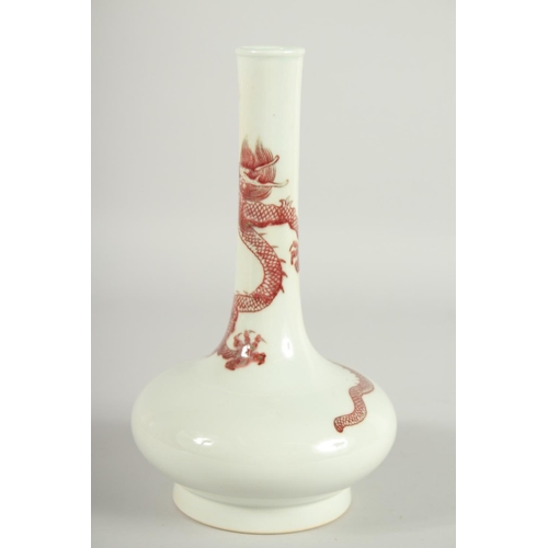 202 - A CHINESE COPPER RED AND WHITE PORCELAIN BOTTLE VASE, the neck with coiled dragon, six-character mar... 