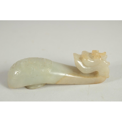 205 - A 19TH CENTURY CHINESE CARVED JADE BELT HOOK, in the form of a dragon, 8.5cm long.