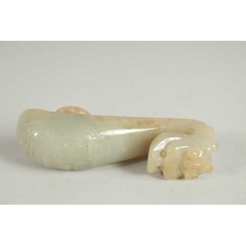 205 - A 19TH CENTURY CHINESE CARVED JADE BELT HOOK, in the form of a dragon, 8.5cm long.