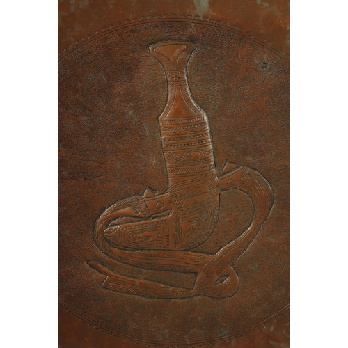 231 - A VERY LARGE AND UNUSUAL 19TH CENTURY OMANI TINNED COPPER TRAY, with central jambiya dagger, 75cm di... 