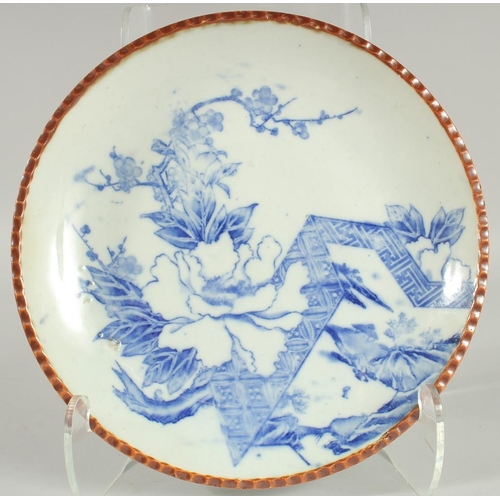 24 - A JAPANESE BLUE AND WHITE IGEZARA PLATE, decorated with flora, 30cm diameter.