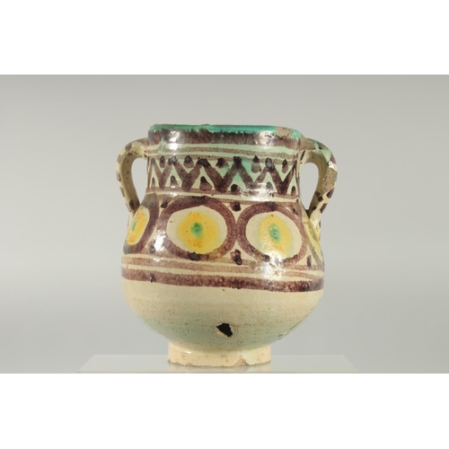 254 - AN 18TH CENTURY MOROCCAN OR TUNISIAN (QALLALIN) POTTERY TWIN HANDLED VASE, 18cm high.