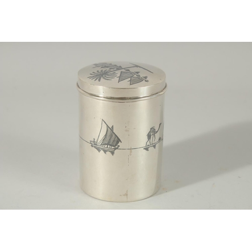 256 - A FINE IRAQI NIELLO INLAID SILVER LIDDED CYLINDRICAL BOX; possibly a tea caddy, 9cm high.