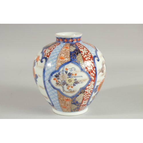 26 - A FINE JAPANESE IMARI PORCELAIN BULBOUS VASE, beautifully painted with panels of birds and native fl... 