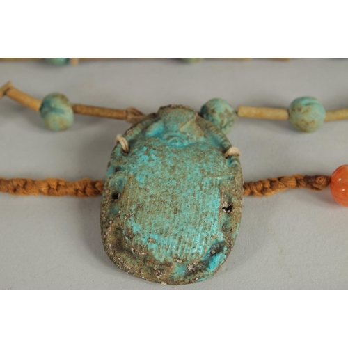 282 - AN EGYPTIAN SCARAB NECKLACE -possibly ancient, together with an agate beaded necklace, and a large O... 