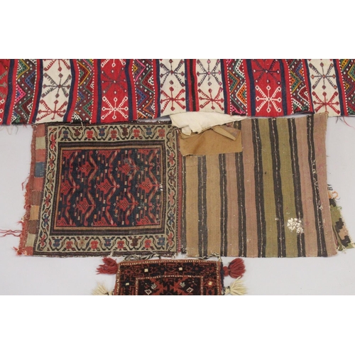 288 - THREE PERSIAN SADDLE BAGS AND RUGS.