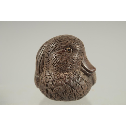 29 - A CHINESE CARVED WOOD FIGURE OF A DUCK, with inset bone character mark, 9cm long.