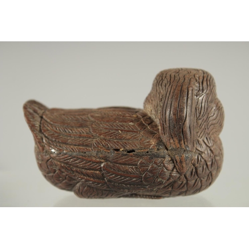 29 - A CHINESE CARVED WOOD FIGURE OF A DUCK, with inset bone character mark, 9cm long.