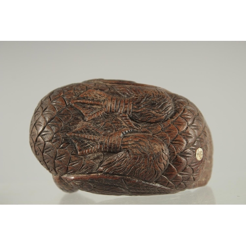 29 - A CHINESE CARVED WOOD FIGURE OF A DUCK, with inset bone character mark, 9cm long.