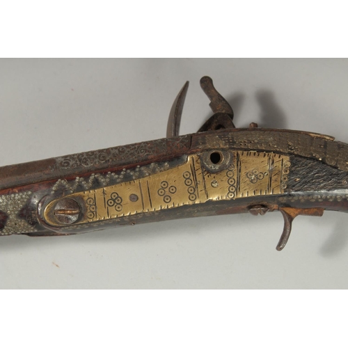 292 - AN OTTOMAN SILVER INLAID FLINTLOCK PISTOL, 43cm.