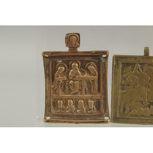 298 - THREE RELIGIOUS BRASS PLAQUES.