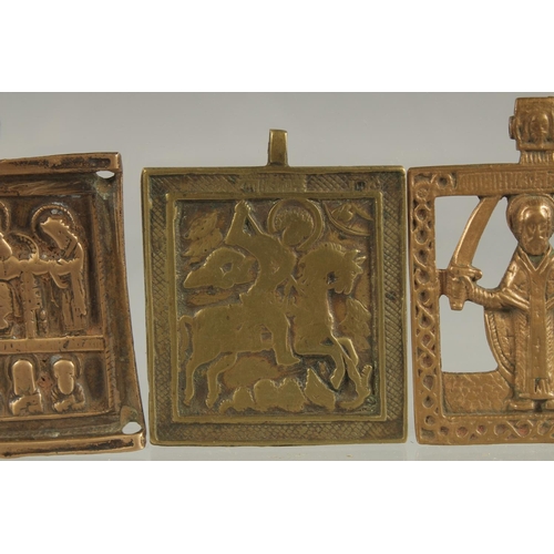 298 - THREE RELIGIOUS BRASS PLAQUES.