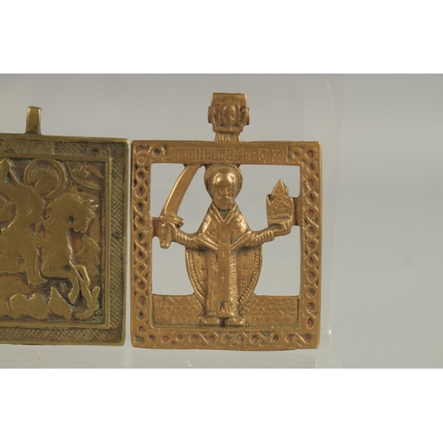 298 - THREE RELIGIOUS BRASS PLAQUES.